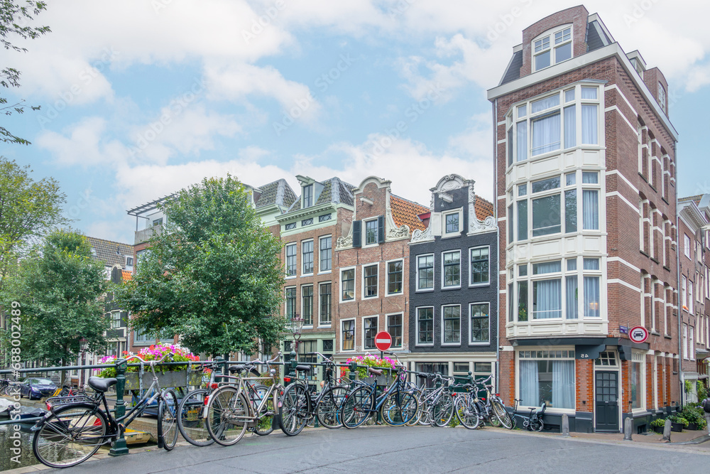 Several Bicycles on the Amsterdam Bridge and Building Facades
