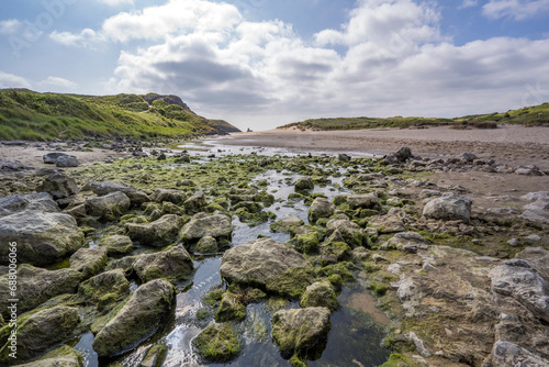 Mossy rocks on Broad Haven beach South Pembrokeshire photo