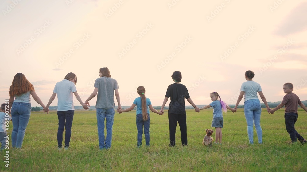 large group of people holding hands. family big community outdoors in the park holding hands together. happy family kid dream concept. people support each other joined hands nature back lifestyle view large group of people holding hands. family big community outdoors in the park holding hands together. happy family kid dream concept. people support each other joined hands nature back lifestyle view