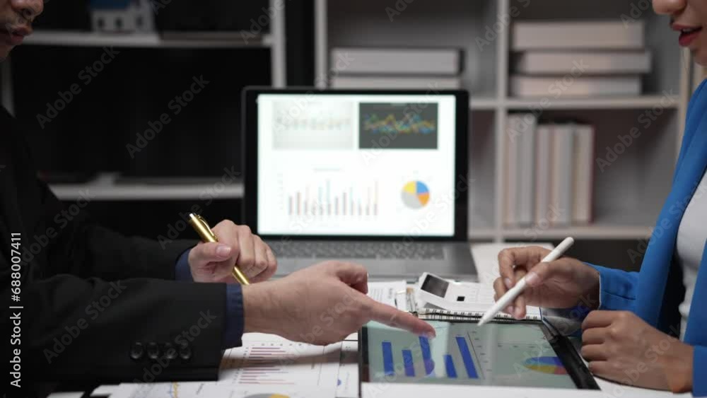 Two investors analyze and write financial data and business reports together, plan strategies and brainstorm at the office together. Finance and Economy business idea Two investors analyze and write financial data and business reports together, plan strategies and brainstorm at the office together. Finance and Economy business idea