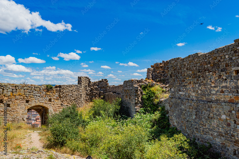 medieval castle ruins in the countryside with blue sky