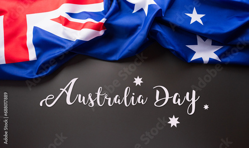 Happy Australia day concept. Australian flag and the text against dark background. 26 January. photo