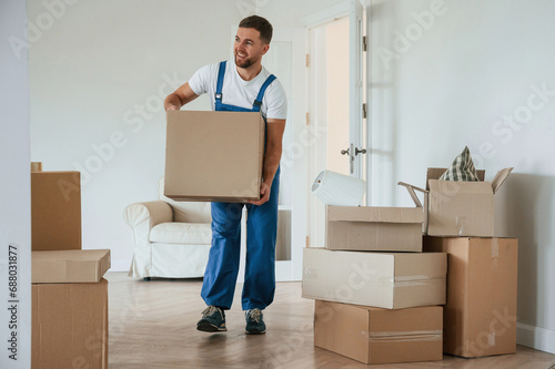 Room full of boxes. Moving service employee © standret