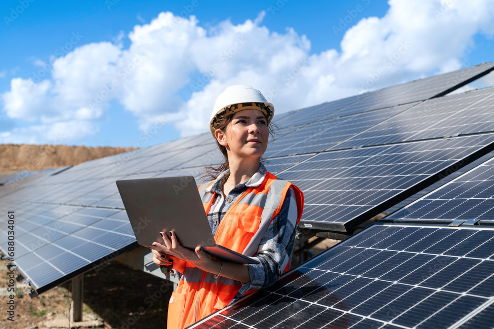 © bulentbaris - Young engineer inspect installation of solar panels installed check with blueprint on the field, with recording inspection data on pc. © bulentbaris - Young engineer inspect installation of solar panels installed check with blueprint on the field, with recording inspection data on pc.