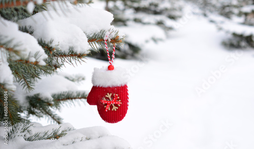 Bild auf Leinwand red mitten toy hanging on the spruce branch in the winter forest copy space