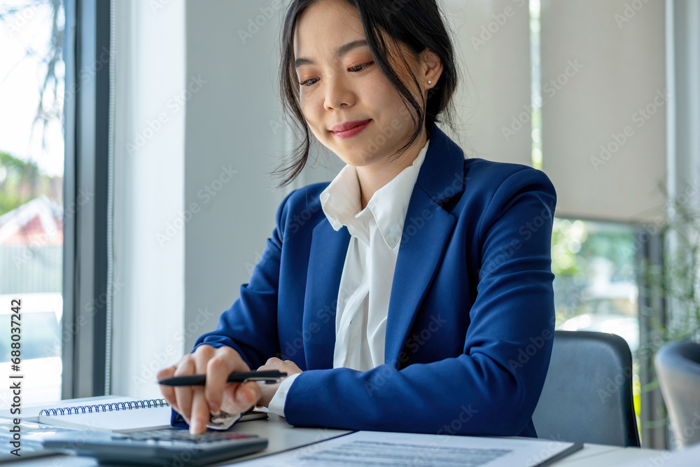 Busineswoman working by using laptop.