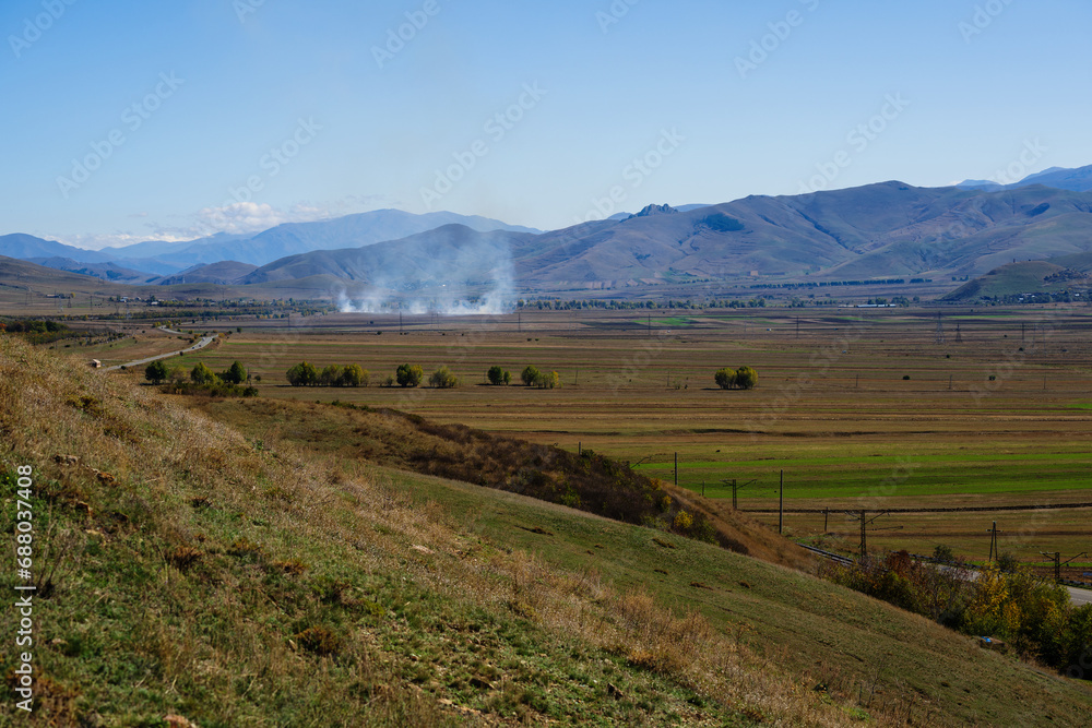 Fototapeta premium Smoky landmark with settlements and fileds, Armenia
