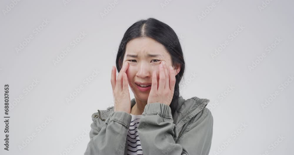 Sad, crying and an Asian woman with depression in studio isolated on a white background. Tears, crisis and person with anxiety, stress and broken heart, trauma and grief, mistake and mental health Sad, crying and an Asian woman with depression in studio isolated on a white background. Tears, crisis and person with anxiety, stress and broken heart, trauma and grief, mistake and mental health