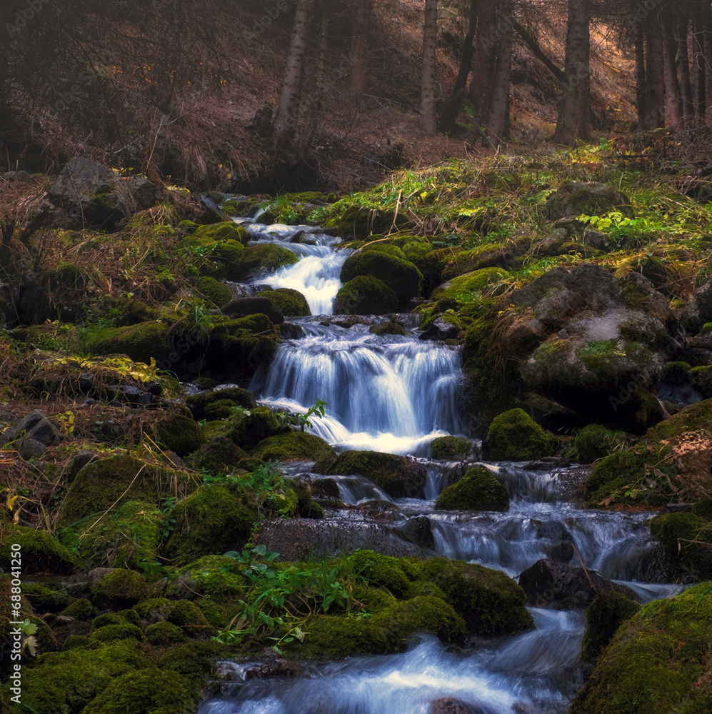 mountain river with blue water in foggy mountain forest in late autumn mountain river with blue water in foggy mountain forest in late autumn