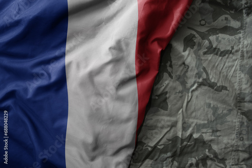 waving flag of france on the old khaki texture background. military concept.