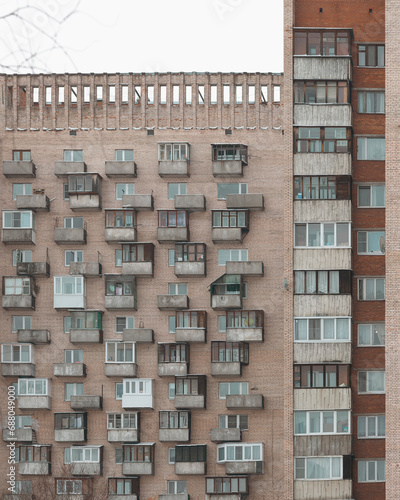 Old facades of brutalist soviet socialist buildings. The gloomy balconies of Russian flats. photo