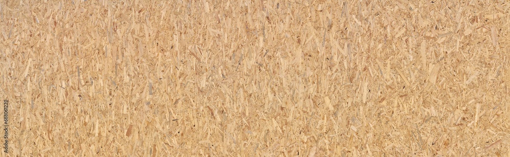 Neue große OSB Grobspanplatte - Textur von zusammengepressten braunen Holzstückchen in Panorama Nahaufnahme - obrazy, fototapety, plakaty 