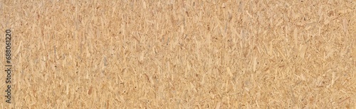 Neue große OSB Grobspanplatte - Textur von zusammengepressten braunen Holzstückchen in Panorama Nahaufnahme