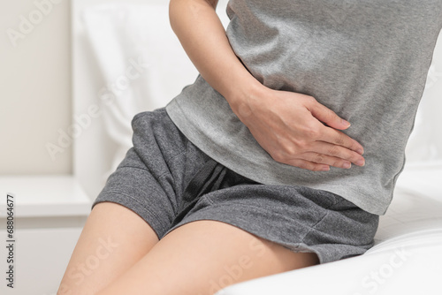Flatulence ulcer, suffering ache young woman hand holding belly, stomach pain from food poisoning, abdominal digestive problem, gastritis or diarrhea. Abdomen inflammation, menstrual period people.