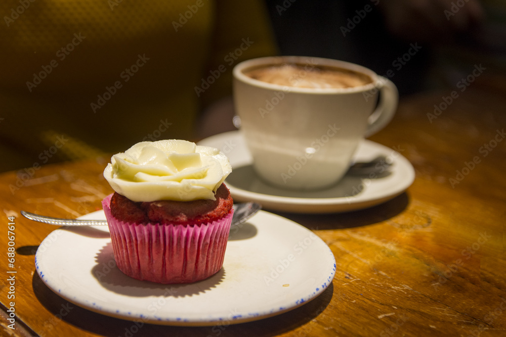 Close up view of a person eating a cake and a coffee Close up view of a person eating a cake and a coffee