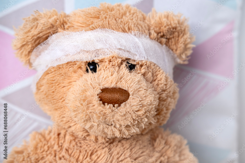 teddy bear with bandaged head, health care and treatment children through soft toy, medical therapy and pediatrics, safety for children