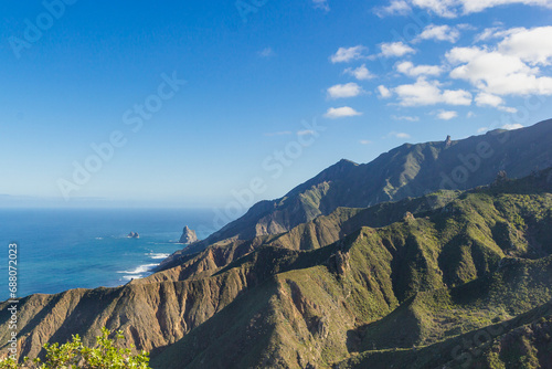 Mirador Risco Magoje with a view of the volcanic island and the sea. Santa Cruz de Tenerife, Spain. Mountain landscape terrain against the background of the blue sky photo