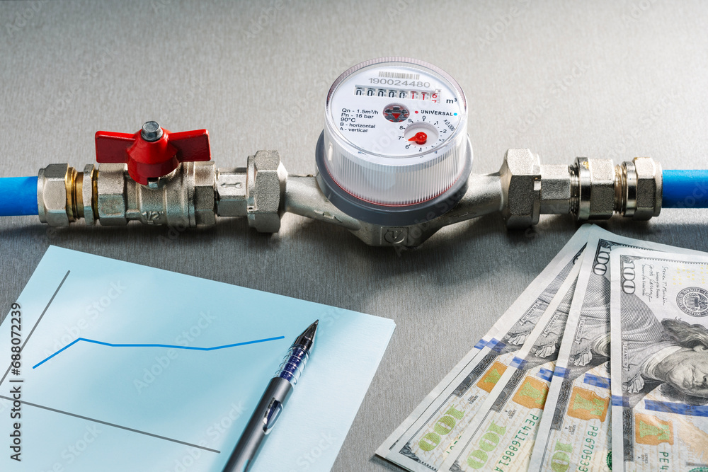 Water meter and us dollars money currency banknotes . Growth of water
