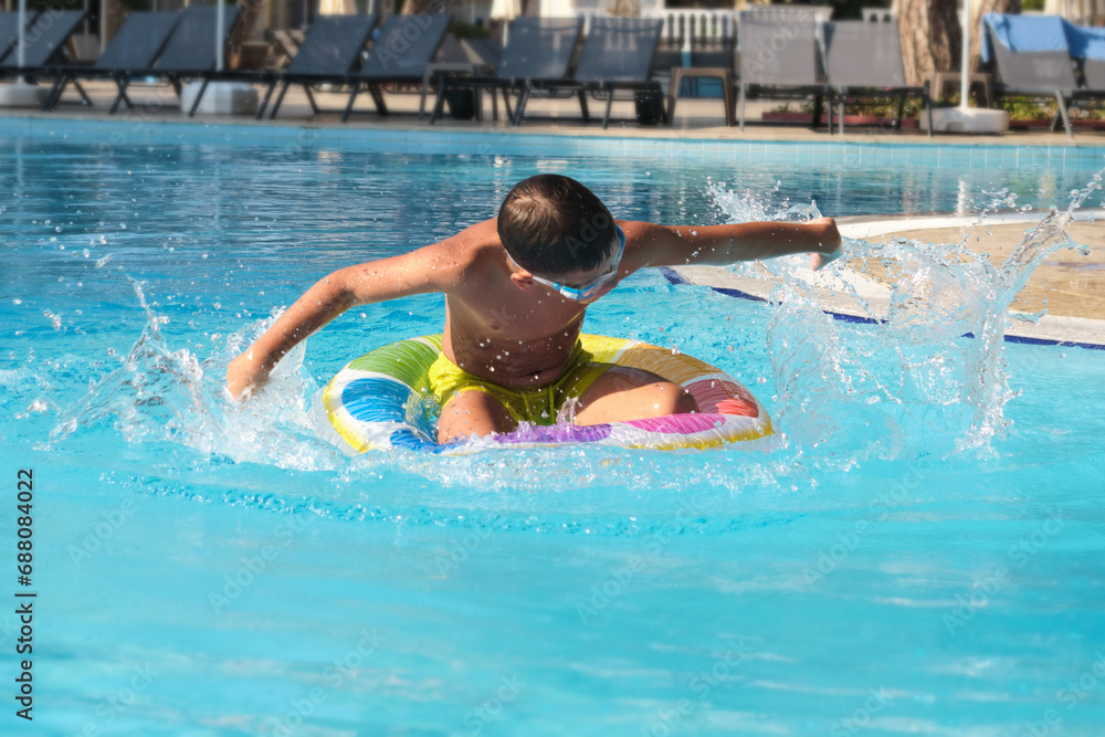 Youthful joy meets luxury relaxation: kid having fun in a modern resort pool