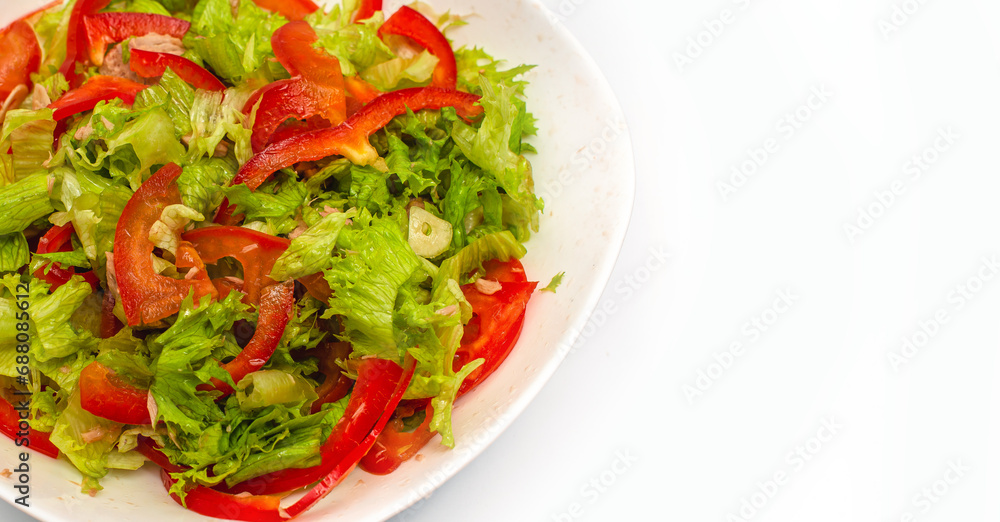 Raw chopped red pepper, lettuce and garlic in white bowl. Healthy vegetable background. Copy space. Raw chopped red pepper, lettuce and garlic in white bowl. Healthy vegetable background. Copy space.