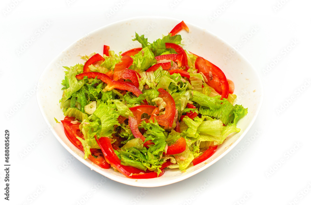 Raw chopped red bell pepper, lettuce and garlic in a white bowl. Healthy vegetable background. Raw chopped red bell pepper, lettuce and garlic in a white bowl. Healthy vegetable background.