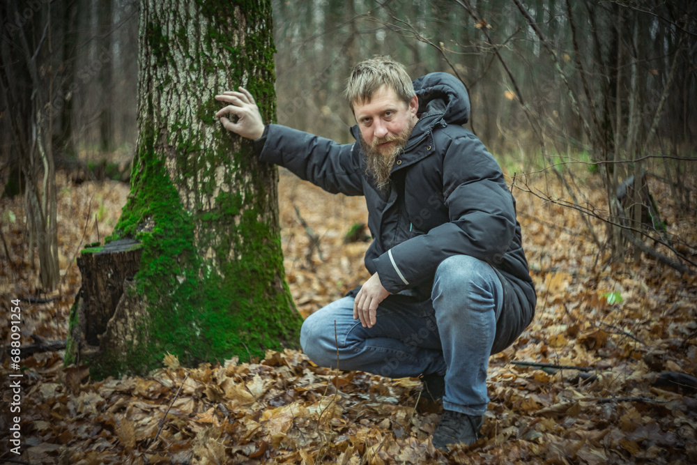 A man with a beard in the forest A man with a beard in the forest