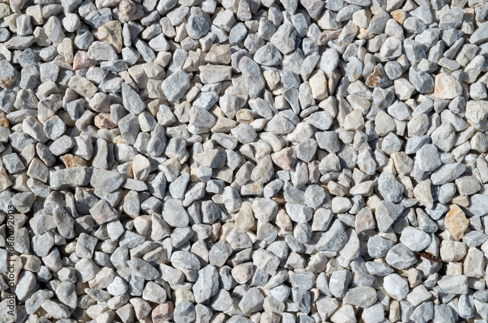 Small white and gray gravel on road closeup Small white and gray gravel on road closeup