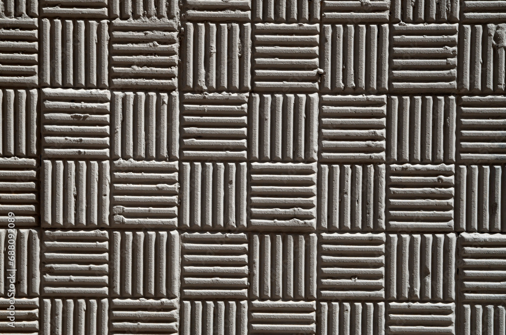 Decorative plaster with relief lines and squares Decorative plaster with relief lines and squares