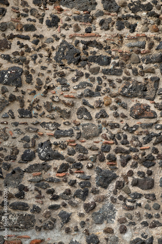 Old black stone wall closeup