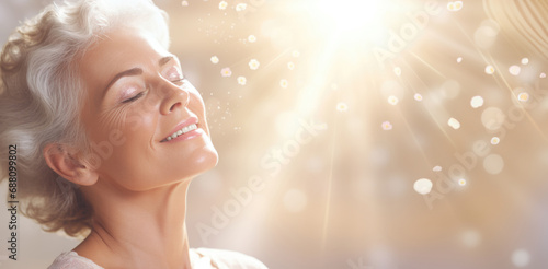 In the gentle rays of the sun, an older woman's portrait reveals serenity, her closed eyes embracing the peaceful embrace of golden sunlight