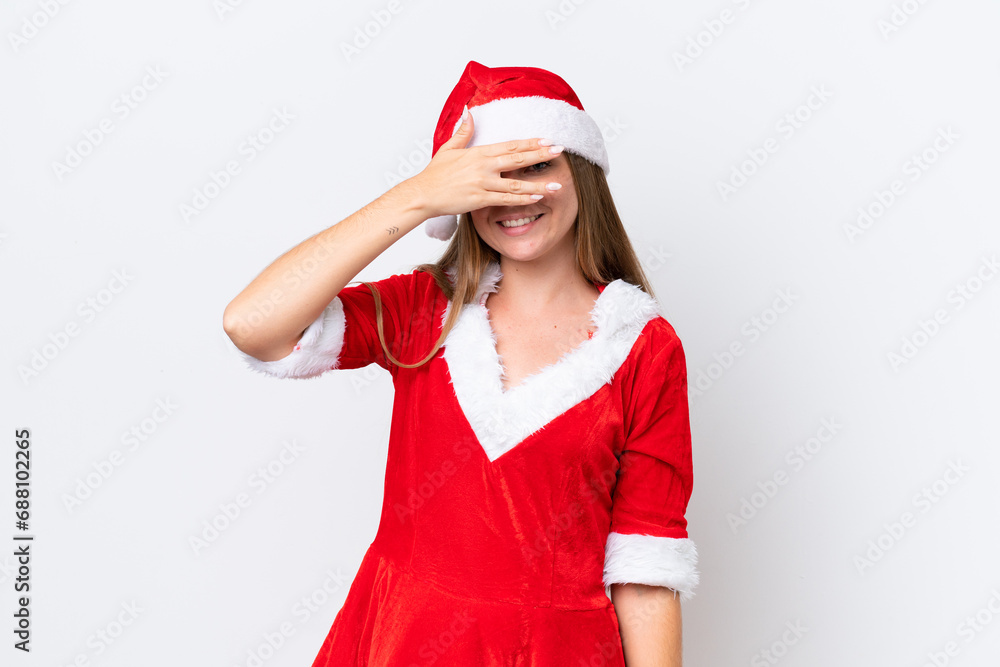 Young caucasian woman dressed as mama noel isolated on white background covering eyes by hands and smiling Young caucasian woman dressed as mama noel isolated on white background covering eyes by hands and smiling