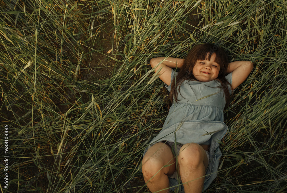 Portrait of a little girl lying on the green grass. Portrait of a little girl lying on the green grass.