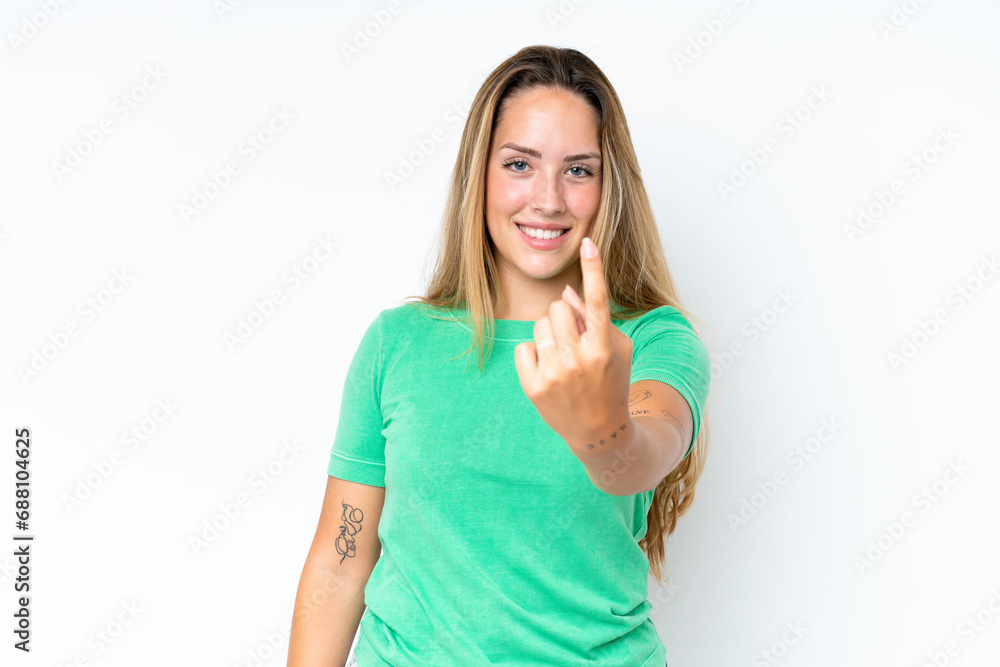 Fototapeta premium Young caucasian woman isolated on white background doing coming gesture