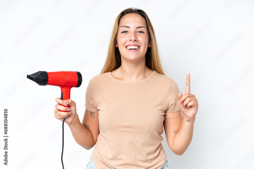 Young caucasian woman holding a hairdryer isolated on white background pointing up a great idea Young caucasian woman holding a hairdryer isolated on white background pointing up a great idea