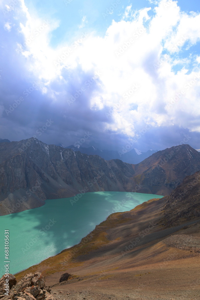 Ala-Köl lake from Ala-Kol mountain pass on seventh stage of Ak-Suu Traverse trek in Tian Shan mountains, Karakol, Kyrgyzstan
