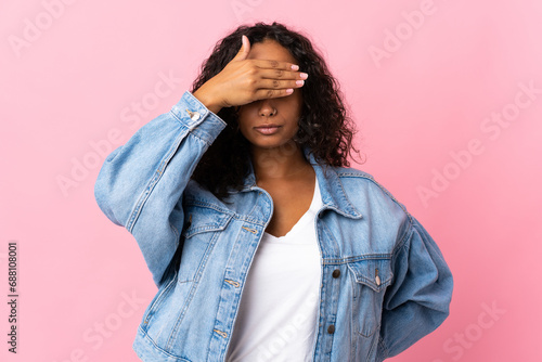 Teenager cuban girl isolated on pink background covering eyes by hands. Do not want to see something photo