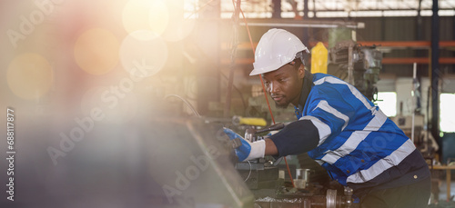 Male engineer worker working with lathe machine, assemble metal pieces, cutting metal parts in industry factory, wearing safety uniform, helmet