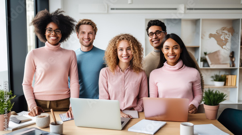 Smiling and successful group of men and women in a company's office