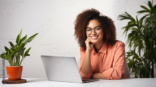 Happy woman working on a laptop in her home office
