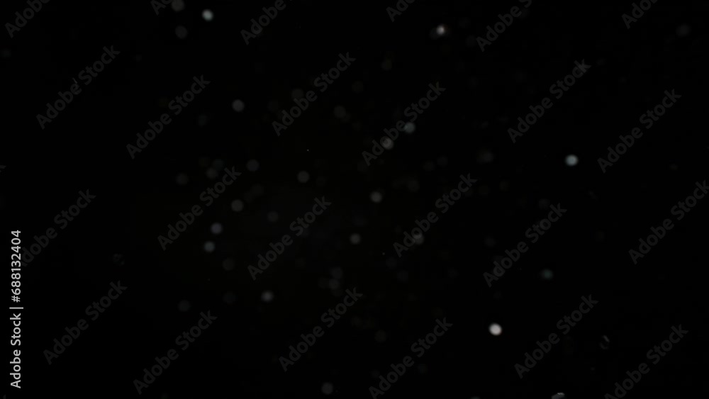 Chaotic abstract movement of silver shiny particles. Bokeh effect. Chaotic abstract movement of silver shiny particles. Bokeh effect.