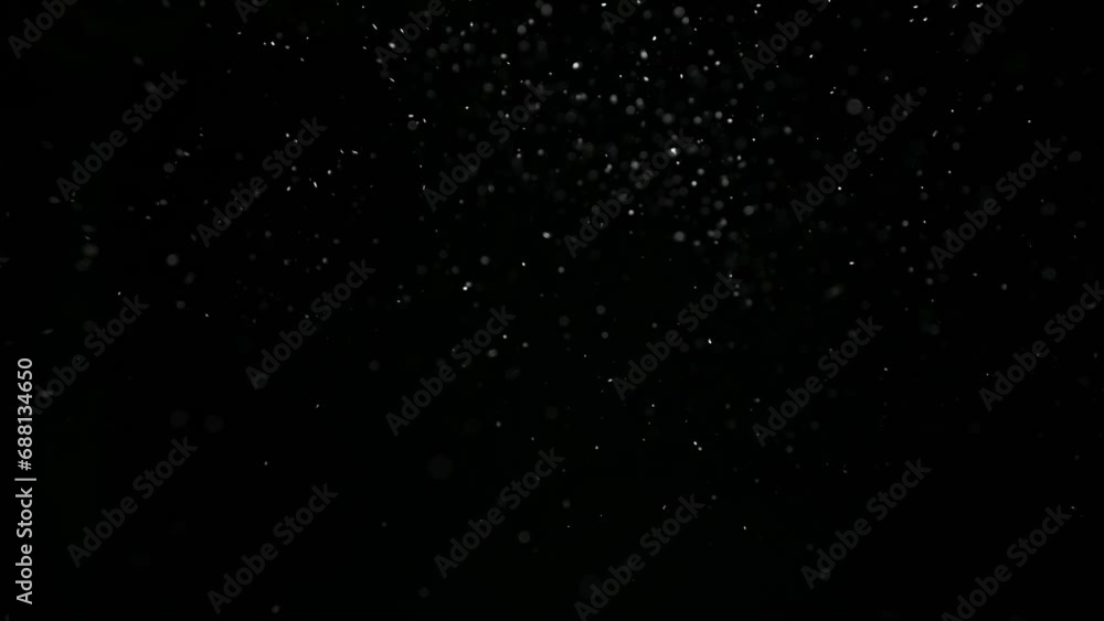 Snowflakes float slowly on a black background. Snowflakes float slowly on a black background.