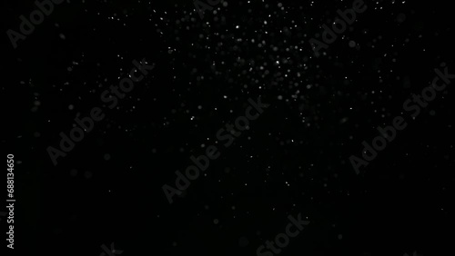 Snowflakes float slowly on a black background. photo