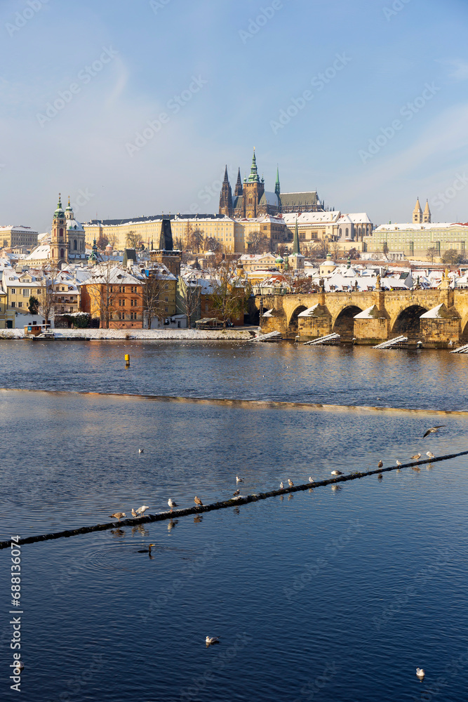 Obraz premium Snowy Prague Lesser Town with Prague Castle and Charles Bridge above River Vltava in the sunny Day , Czech republic