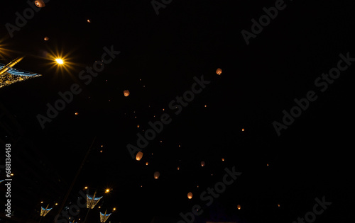 Chinese lanterns released into the air light up the sky and the Christmas decoration Pamplona Spain