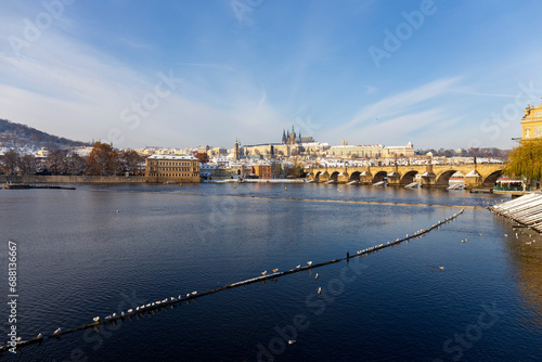 Snowy Prague Lesser Town with Prague Castle and Charles Bridge above River Vltava in the sunny Day , Czech republic