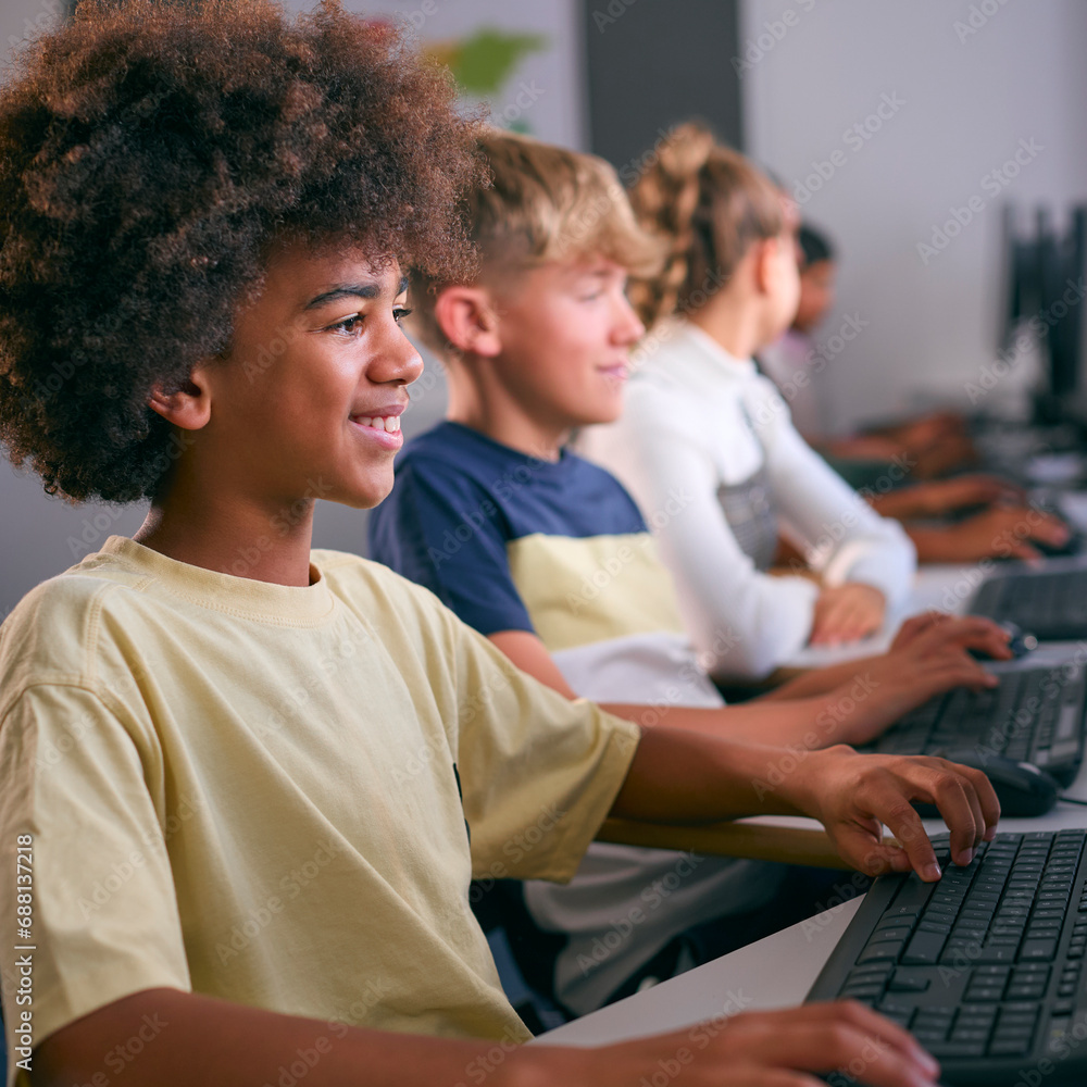 Obraz premium Multi-Cultural Group Of Secondary Or High School Students At Computers In IT Class 
