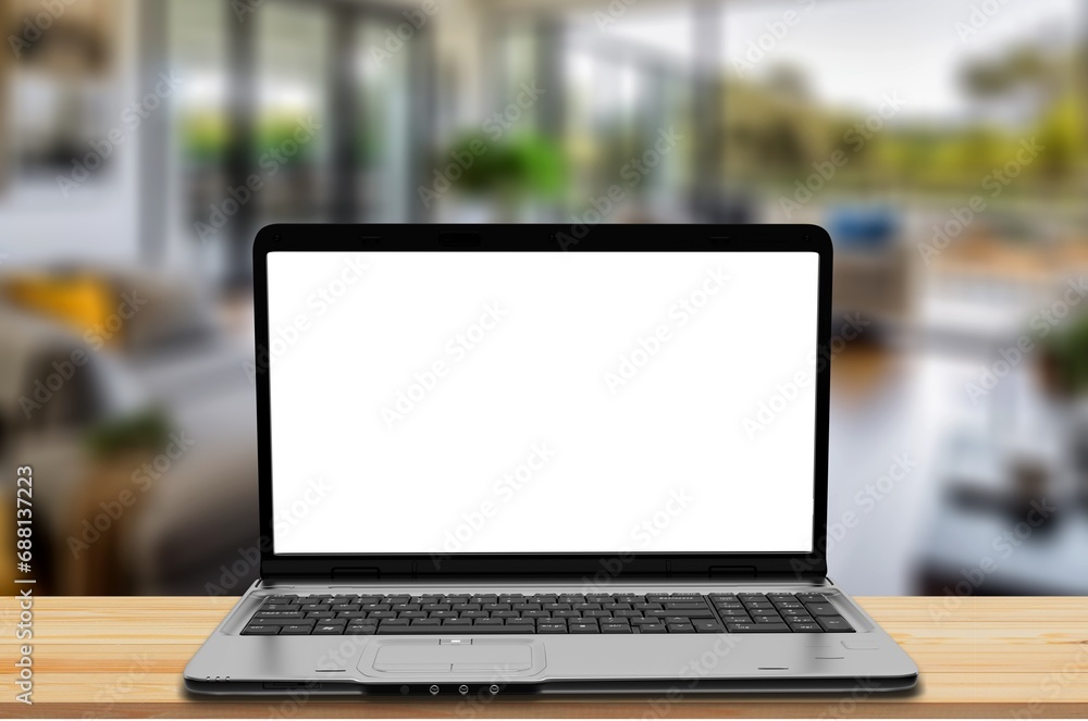 Modern laptop with white blank screen on desk Modern laptop with white blank screen on desk