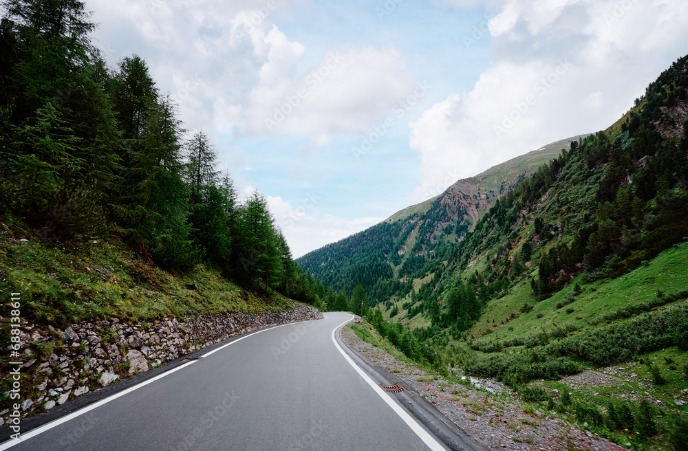 Asphalt road in Alps mountains forest. Road trip concept. Beautiful landscape. Asphalt road in Alps mountains forest. Road trip concept. Beautiful landscape.