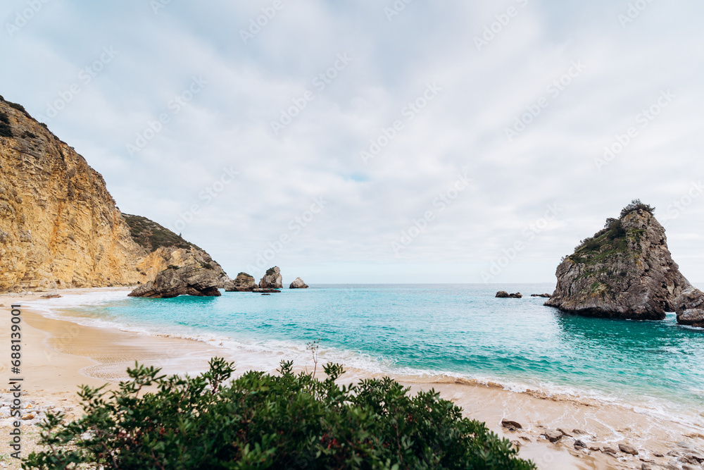 Fototapeta premium Secret beach in Sesimbra with high cliffs and sky blue water - Praia do Ribeiro do Cavalo
