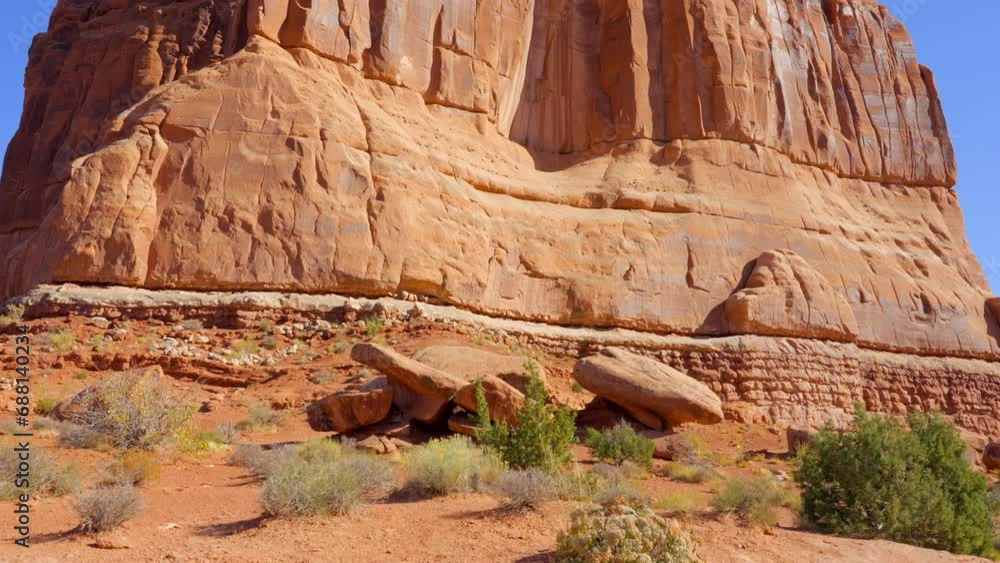 Establishing shot of mountain trail with red rocks background in La Sal Mountains, Arches National Park, Utah, North America. Day time on October 2023. Still camera view. ProRes 422 HQ. Establishing shot of mountain trail with red rocks background in La Sal Mountains, Arches National Park, Utah, North America. Day time on October 2023. Still camera view. ProRes 422 HQ.